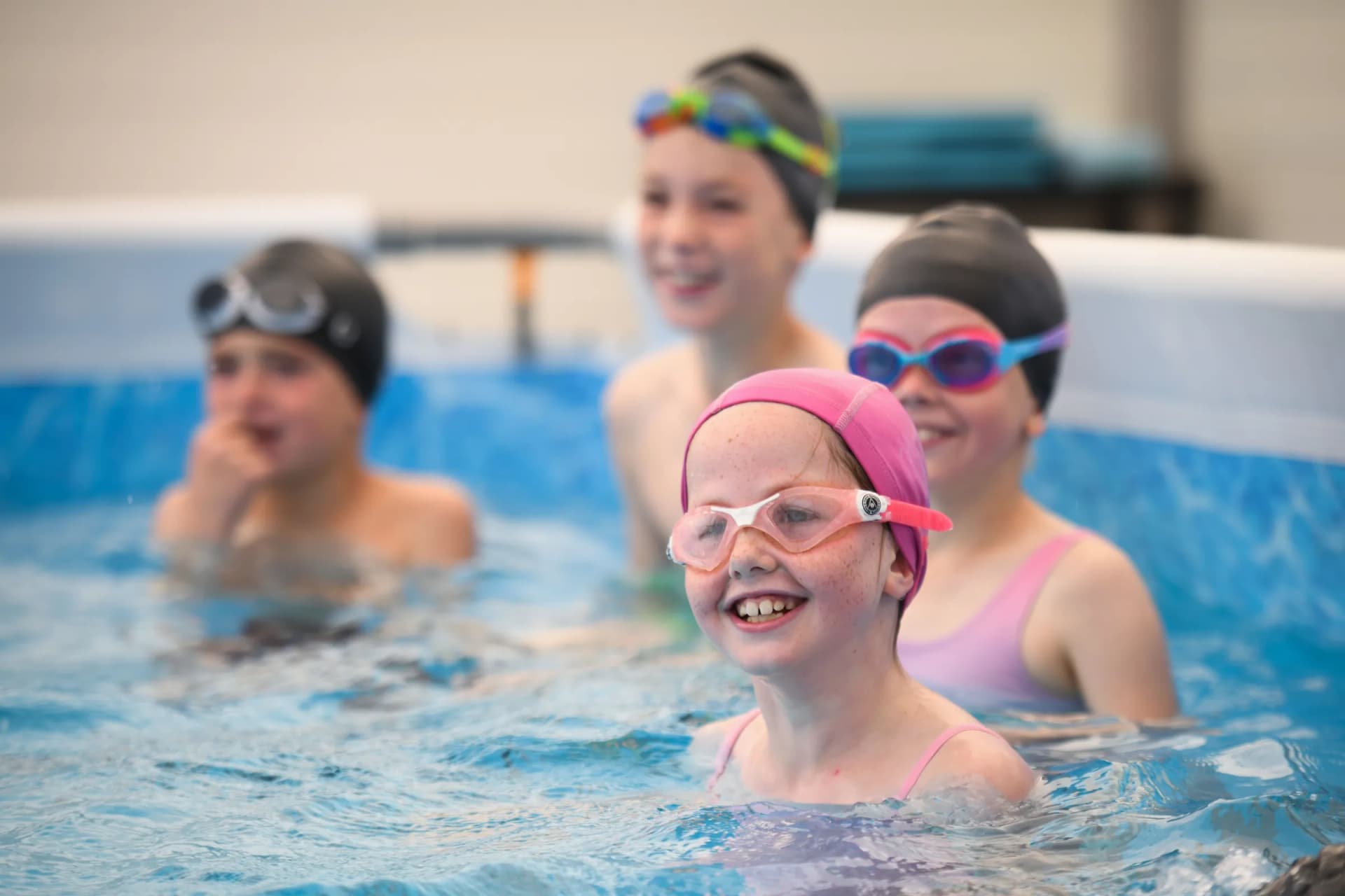 Children taking part in a Swim Learn Achieve on-site swimming session