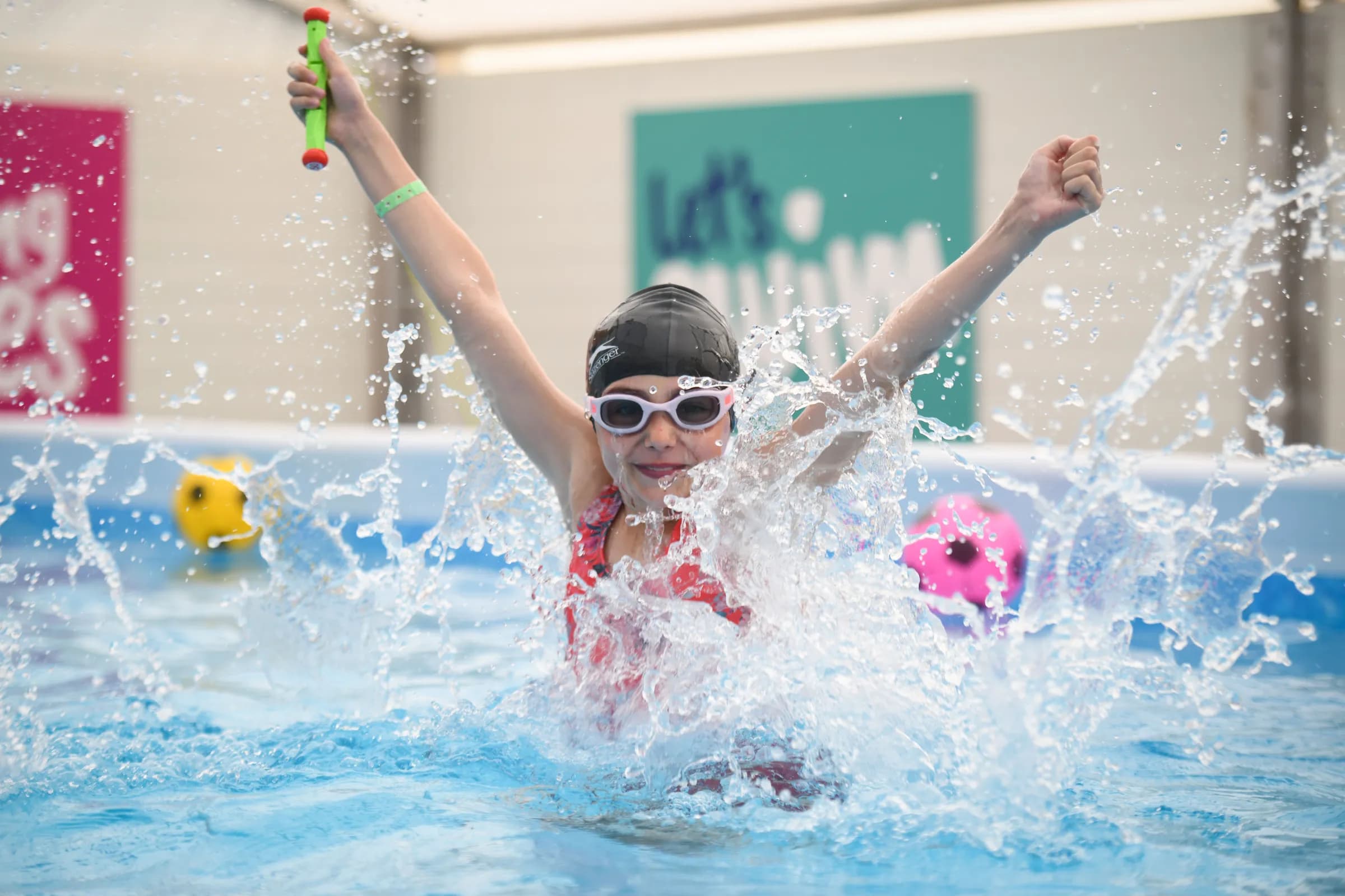 Pupil enjoying a Swim:ED swimming session while creating a large splash in the pool