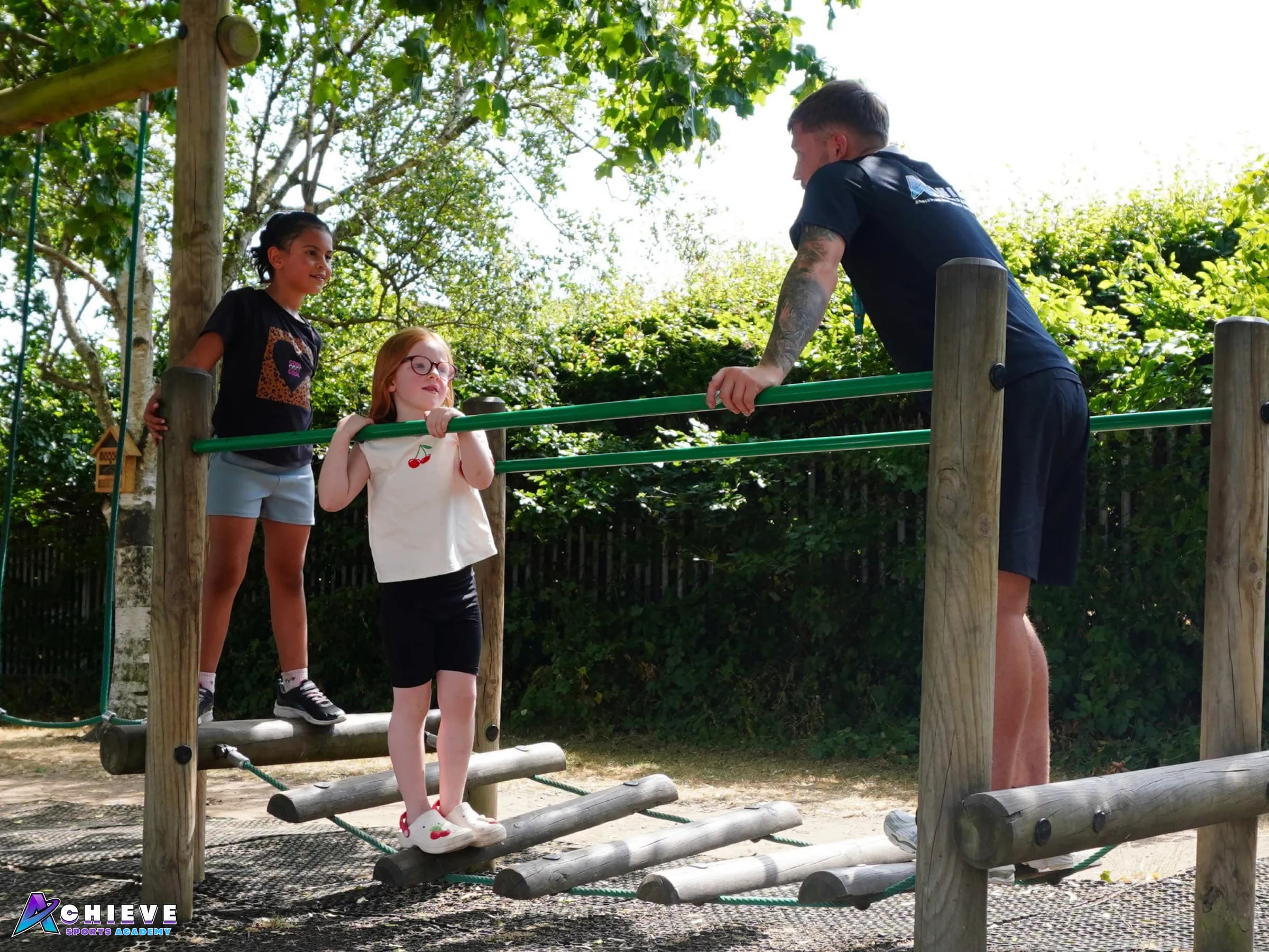Children and coaches on a school sports field during a Sport Learn Achieve session
