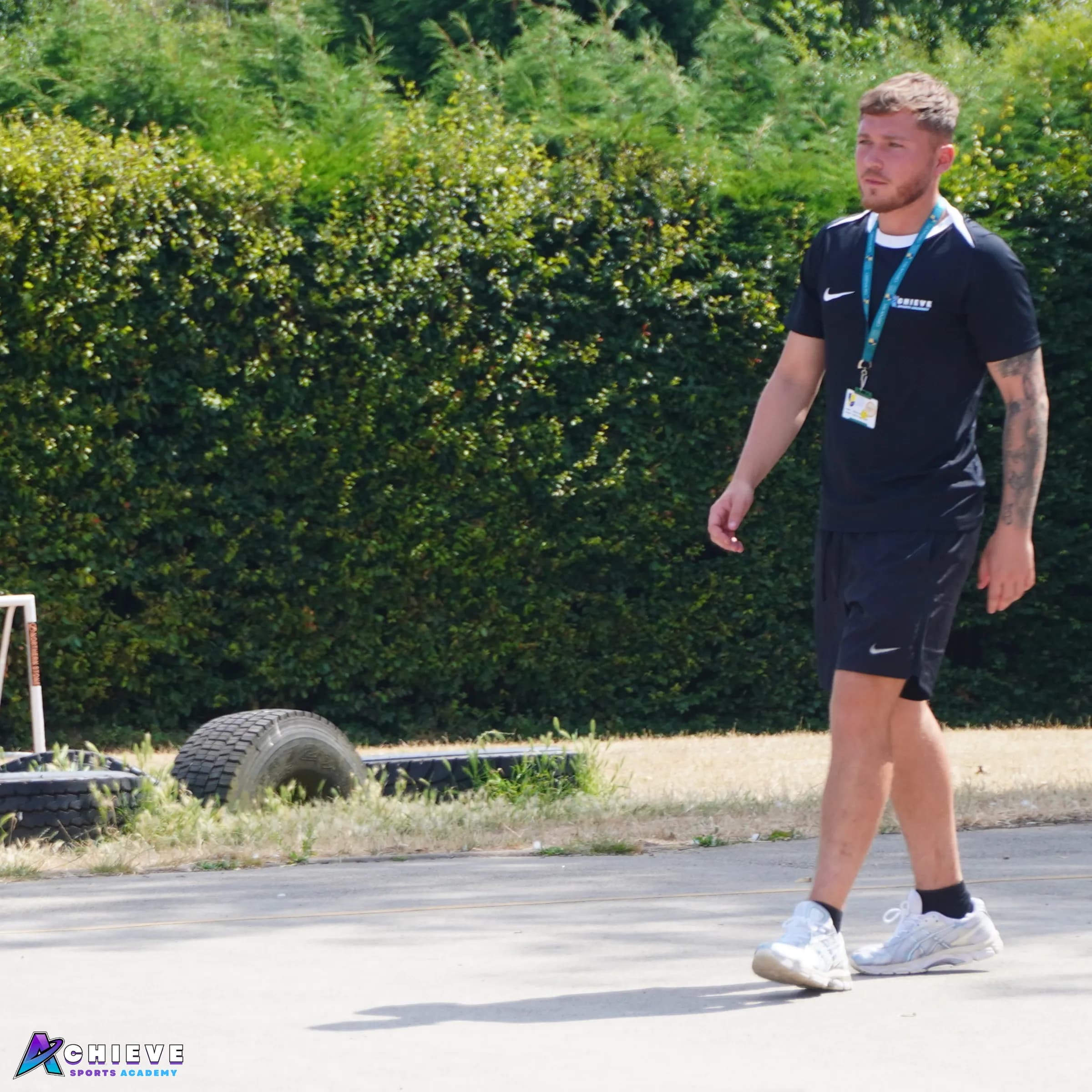 An Achieve Sports Academy coach on a school playground during a session